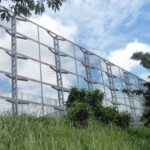 A massively high fence. What is it protecting? Singapore's Kaiju Farm?
