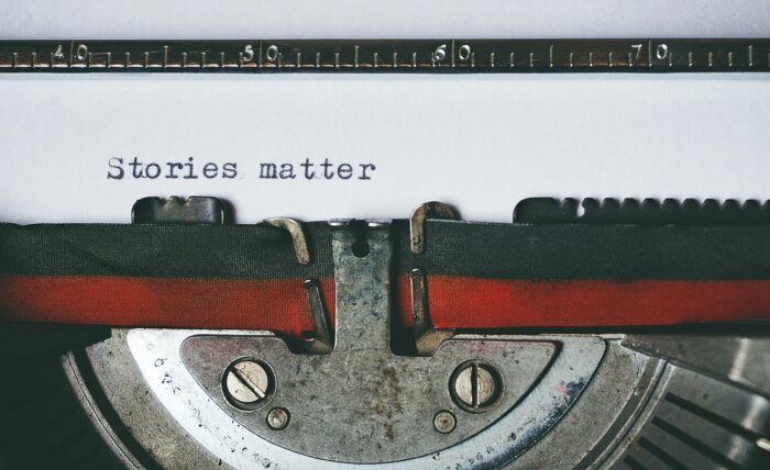 A typewriter writing the words, 'stories matter'.