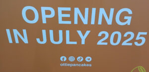 Ottie Pancakes - Orange with white lettering: OPENING IN JULY 2025 Underneath socialmedia icons (Facebook, Instagram, TikTok, Telegram) ottiepancakes.