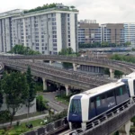 The LRT in the foreground with Punggol Waterway behind, as seen from the roof of One Punggol.